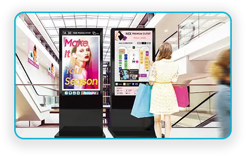 Shopping mall retail wayfinding kiosks beside a promotional signage screen
